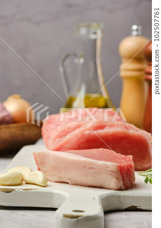 Closeup view of uncooked raw pork fillet cut on slices 102507761