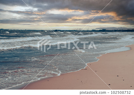 Baltic sea Dark blue clouds and sea or ocean water surface with foam waves before storm, dramatic seascape background sunsets. Abstract pattern texture. 102508732