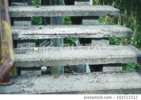 Old narrow concrete staircase on green grass background Old narrow concrete staircase on green grass background 102511512
