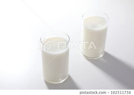 Milk poured into the glass Milk poured into the glass 102511738