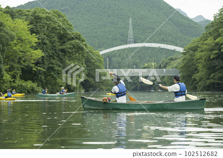 Man enjoying river kayak with friends Man enjoying river kayak with friends 102512682