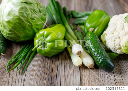 Green raw vegetables on wooden background. Healthy organic food. 102512811