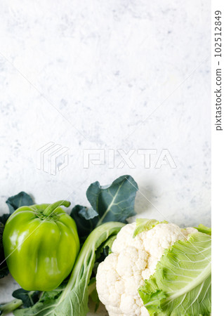 Border of green raw vegetables on white background. Top view of healthy organic food. Copy space 102512849