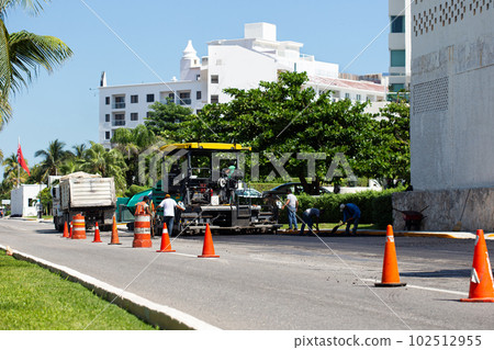 Road construction works. Traffic cones at street warning about asphalt pavement works . Road construction works. Traffic cones at street warning about asphalt pavement works . 102512955