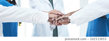 Hand stack, group and doctors with teamwork, motivation and support for healthcare services at clinic. Men, women and medic team building with hands, solidarity and together at hospital for wellness 102513653