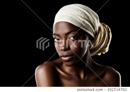 Simplicity is the ultimate in sophistication. Studio portrait of a beautiful woman wearing a headscarf against a black background. Simplicity is the ultimate in sophistication. Studio portrait of a beautiful woman wearing a headscarf against a black background. 102514702