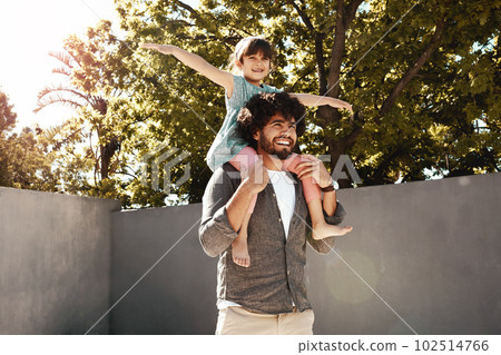 Dad makes every day so exciting. a father giving his little daughter a piggyback ride outdoors. 102514766