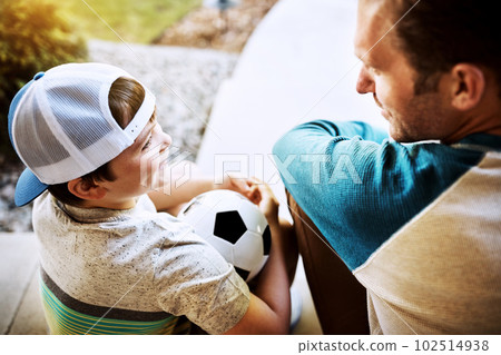 Give them the one-on-one attention they deserve. Rearview shot of a father and his son bonding on their porch at home. 102514938