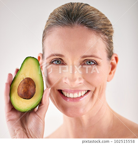 This will make your skin happy. Cropped studio portrait of a mature woman holding up an avocado. 102515558