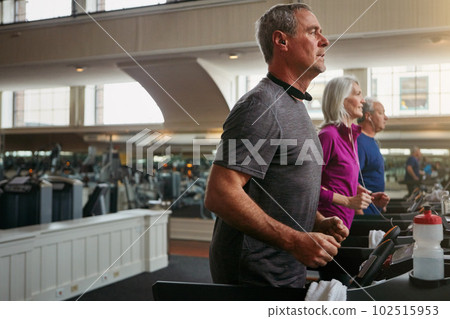 Training hard to improve the quality of their lives. a group of mature people exercising on treadmills at the gym. Training hard to improve the quality of their lives. a group of mature people exercising on treadmills at the gym. 102515953