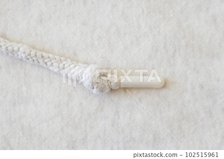 Woven background with beige string close-up with bokeh. Women's sportswear 102515961