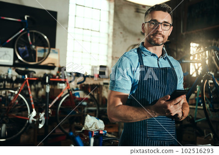 My direct line to customers. Portrait of a mature man working in a bicycle repair shop. 102516293