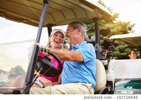 Its the only way to get travel on a golf course. an affectionate mature couple spending a day on the golf course. 102516648