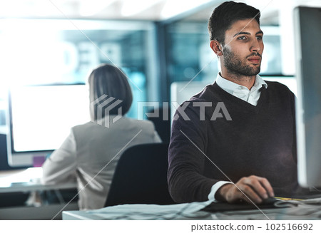 Focused on succeeding. a young businessman working on his computer at his desk. 102516692