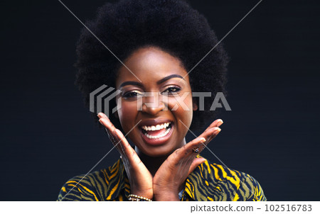 Embrace your beauty. a happy young woman posing against a dark background. 102516783