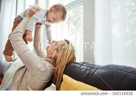 My life is filled with joy, happiness, wonder and love. a happy young mother playing with her baby boy at home. My life is filled with joy, happiness, wonder and love. a happy young mother playing with her baby boy at home. 102516816