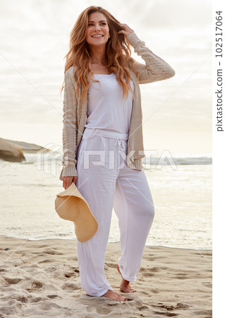 It was such a good idea to get out today. a young woman spending some time at the beach. 102517064
