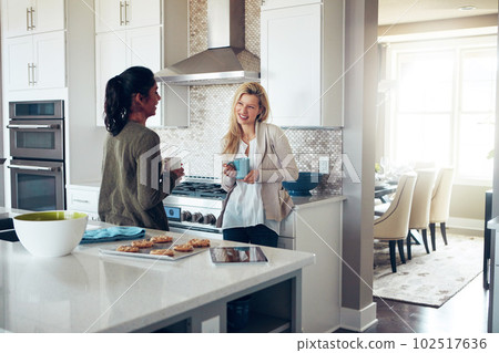 Nothing beats coffee and a great catch up session. two young women having coffee together on a relaxing day at home. 102517636