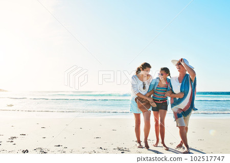 Girls day at the beach. Full length shot of a senior woman spending the day at the beach with her daughter and granddaughter. Girls day at the beach. Full length shot of a senior woman spending the day at the beach with her daughter and granddaughter. 102517747