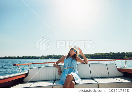 Cruising along without a care in the world. Portrait of an attractive young woman spending the day on her private yacht. 102517858