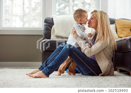 Her love is boundless, endless, seamless, selfless and unconditional. a happy young mother playing with her baby boy at home. Her love is boundless, endless, seamless, selfless and unconditional. a happy young mother playing with her baby boy at home. 102518493