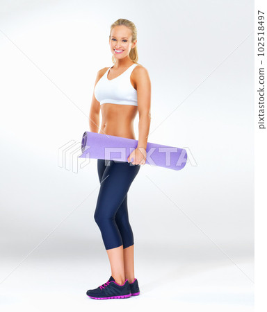 Im pumped to get exercising. Studio shot of an attractive young woman in exercise clothing against a gray background. 102518497