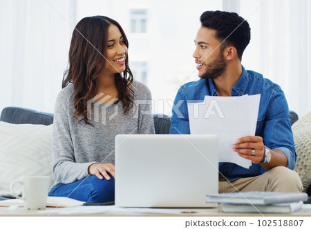 Now what paid secrets of yours will I find here. a happy young couple sitting on the sofa while going through paperwork in their lounge. Now what paid secrets of yours will I find here. a happy young couple sitting on the sofa while going through paperwork in their lounge. 102518807