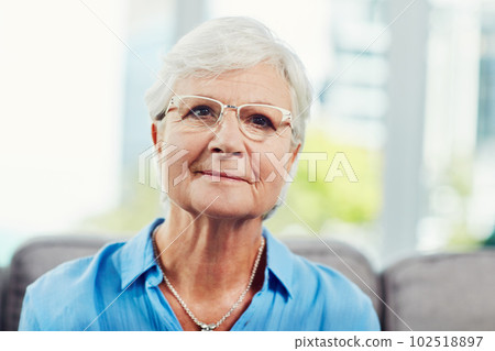 Content in my retirement. Cropped portrait of a senior woman sitting on her sofa at home. 102518897