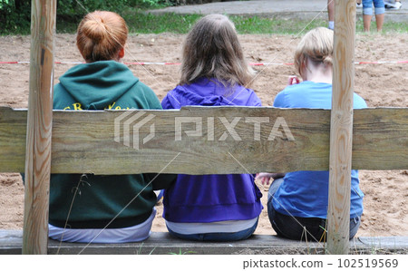 Rear view of German girls in their mid-teens sitting on a bench. Hair color varies and there is no hair color school like in Japan 102519569
