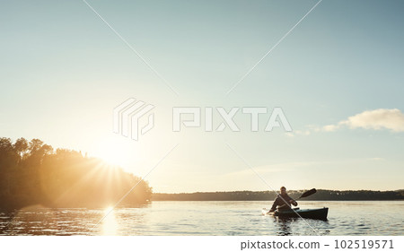 Everything you need. a young man kayaking on a lake outdoors. Everything you need. a young man kayaking on a lake outdoors. 102519571