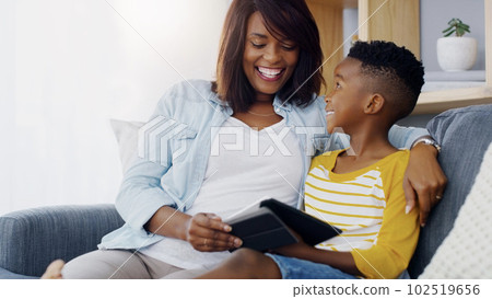 Hes teaching me a thing or two about apps. an adorable little boy using a digital tablet with his mother at home. Hes teaching me a thing or two about apps. an adorable little boy using a digital tablet with his mother at home. 102519656