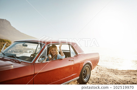 Taking a trip along Mother Natures highway. a beautiful young woman going on a road trip to the beach. 102519970