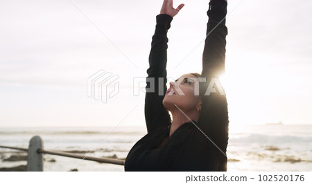 Let go of all the negativity surrounding you. a woman practising yoga on the promenade. 102520176