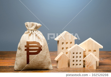 Houses and philippine peso money bag. Community municipal budget. Investments in real estate and construction industry. Energy efficiency and costs for heating and home services. Overheated market. Houses and philippine peso money bag. Community municipal budget. Investments in real estate and construction industry. Energy efficiency and costs for heating and home services. Overheated market. 102520208