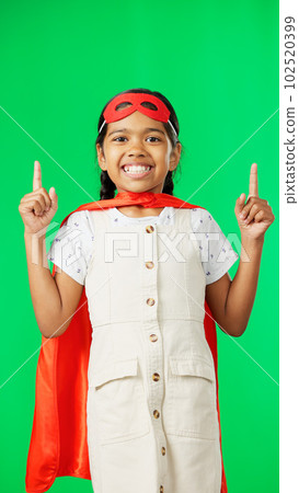 Superhero, point and face of child on green screen for fantasy, cosplay costume and comic character. Advertising, copy space and portrait of kid in studio for freedom, fight crime and games mockup 102520399
