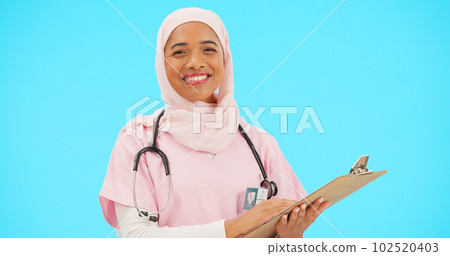 Woman, doctor and clipboard portrait in studio for information or medical records. Islamic or muslim female and professional nurse in hijab with smile and document for healthcare on blue background 102520403