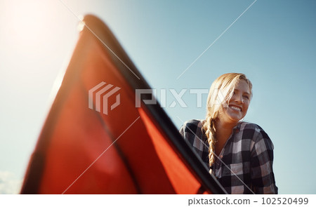 Water enthusiast doing what she does best. an attractive young woman spending a day kayaking on the lake. 102520499