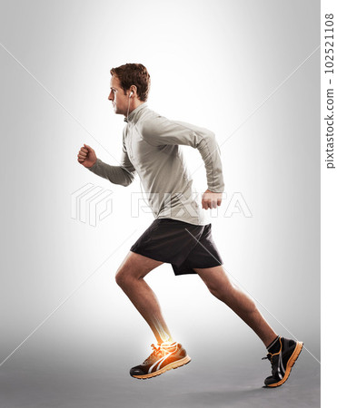 Man running, exercise and ankle pain with overlay, fitness injury and medical emergency on studio background. X ray, anatomy and skeleton with male runner with injured foot, inflammation and sprain Man running, exercise and ankle pain with overlay, fitness injury and medical emergency on studio background. X ray, anatomy and skeleton with male runner with injured foot, inflammation and sprain 102521108