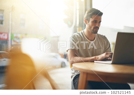 Coffee shop, working and man with laptop and lens flare doing code remote work in a cafe. Tech, email and male freelancer customer at a restaurant and computer writing with focus on web coding 102521145