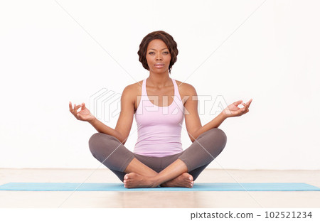 Yoga, portrait and woman in lotus pose on studio floor for fitness, peace and wellness on white background. Face, exercise and African female with mockup for holistic workout, mental health and zen Yoga, portrait and woman in lotus pose on studio floor for fitness, peace and wellness on white background. Face, exercise and African female with mockup for holistic workout, mental health and zen 102521234