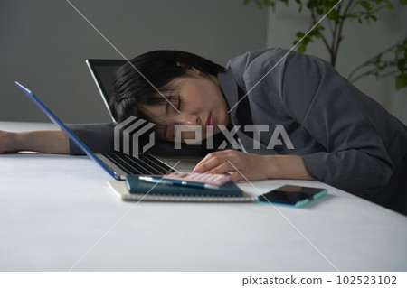 Businesswoman sleeping tired after working overtime in office 102523102