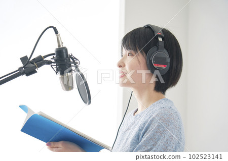 Female narrator narrating in studio Female narrator narrating in studio 102523141