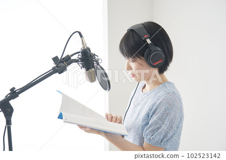 Female narrator narrating in studio 102523142