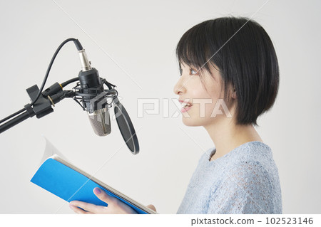 Female voice actor dubbing in studio Female voice actor dubbing in studio 102523146