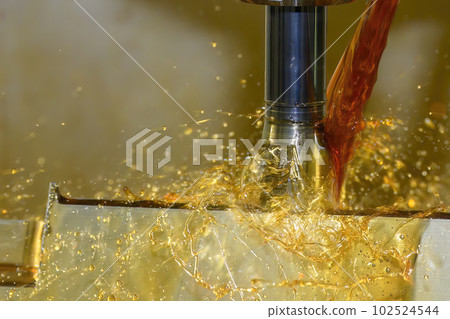 lose up scene the CNC milling machine cutting the  mold parts with oil coolant method. 102524544