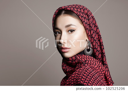 beautiful young woman in veil and jewelry 102525206