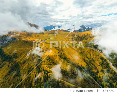 With its cloudswept slopes, the celebrated Giau Pass is accompanied by a majestic mountain range With its cloudswept slopes, the celebrated Giau Pass is accompanied by a majestic mountain range 102525220