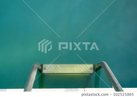 Swimming pool with dirty green water close-up. 102525865