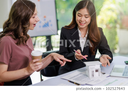 Home sales,home rental and real estate concept.Real estate agent explain about the terms of the home purchase or rental agreement to customer before sign contract Home sales,home rental and real estate concept.Real estate agent explain about the terms of the home purchase or rental agreement to customer before sign contract 102527643