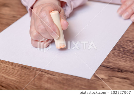 [Woman stamping stamp] 102527907